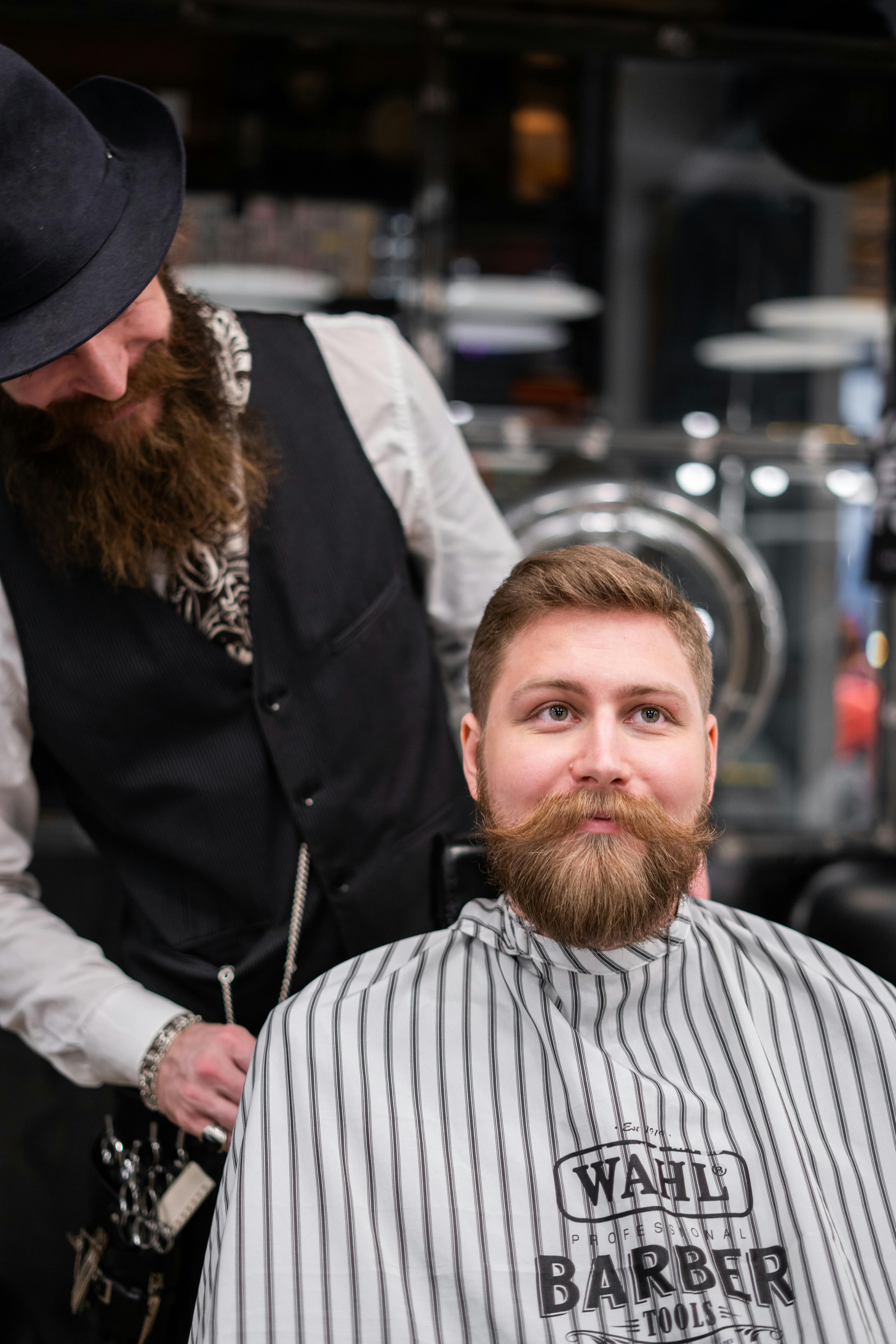 Professional barber attending to a client in a modern barbershop