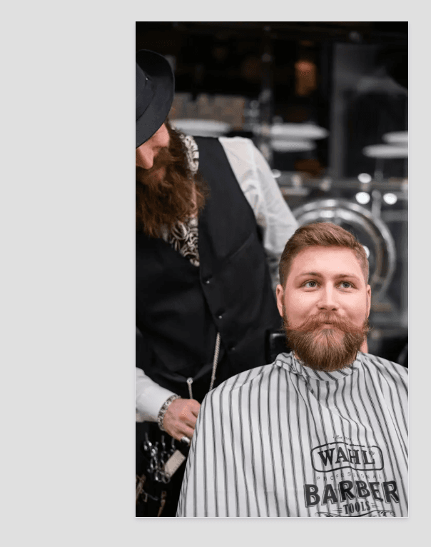 Professional barber with client in a modern barbershop